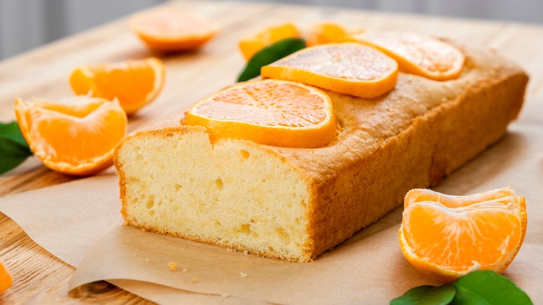 An orange cake over a wooden board