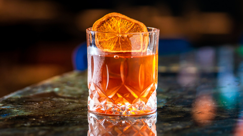 Old fashioned cocktail in glass on bar
