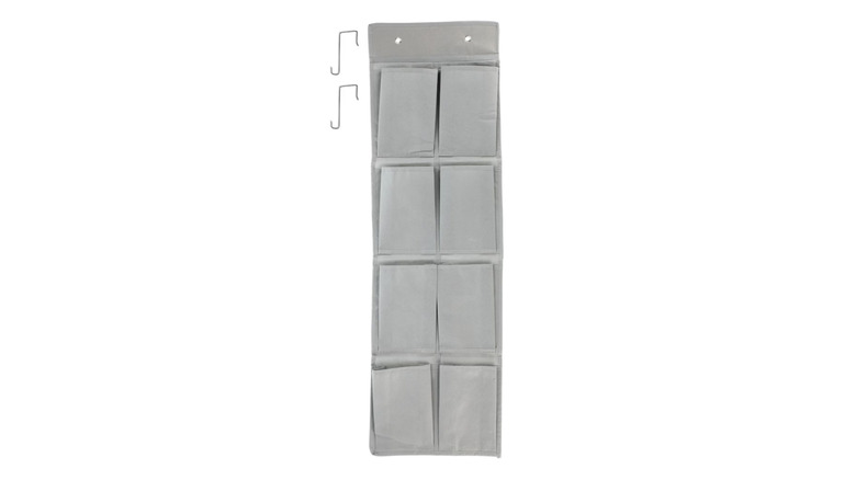 A gray, over-the-door shoe organizer.