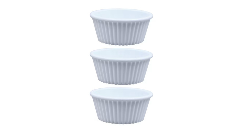 Three white plastic ramekins.