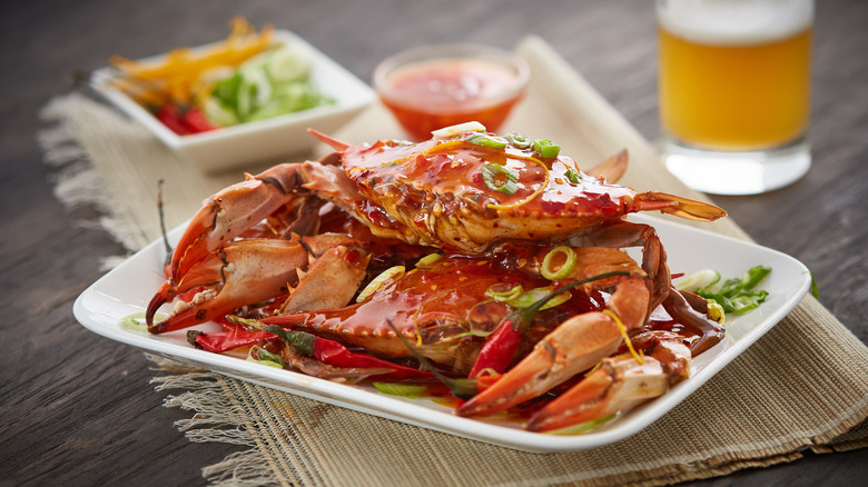 crab dish with drink in background