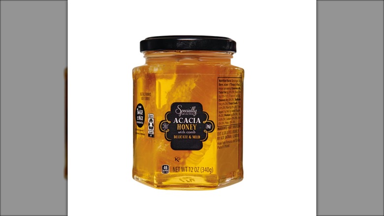 jar of acacia honey with comb