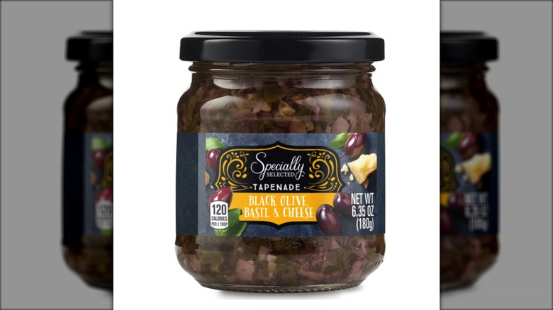 jar of black olive tapenade with basil and cheese