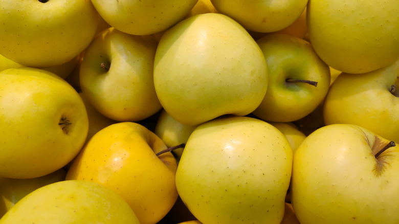 Golden Delicious apples piled up