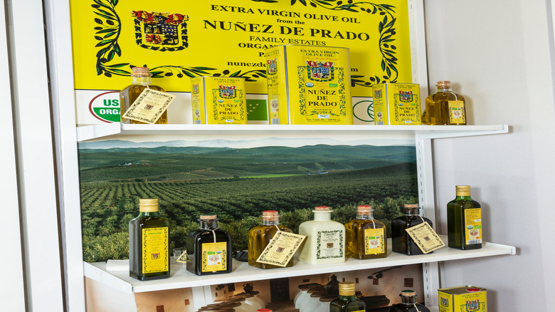 Various containers of Nuñez de Prado olive oil on a display shelf