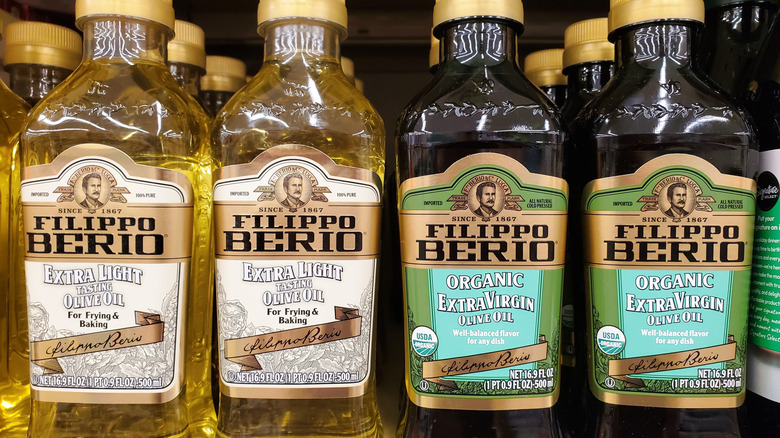 Bottles of Filippo Berio olive oil displayed on a supermarket shelf