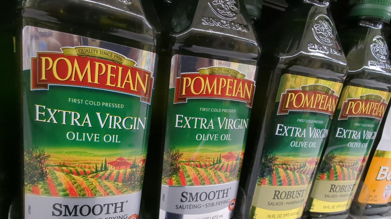 Pompeian Smooth and Robust olive oil bottles on a supermarket shelf
