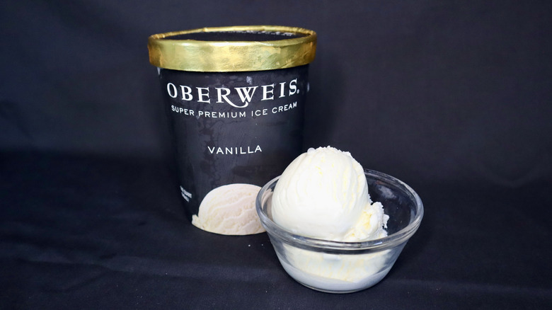 ice cream in bowl in front of black Oberweis container