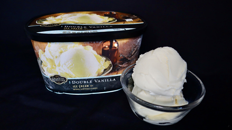 ice cream in bowl in front of black Private Selection container