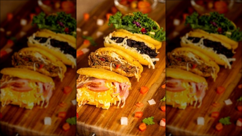four arepas on a wooden table