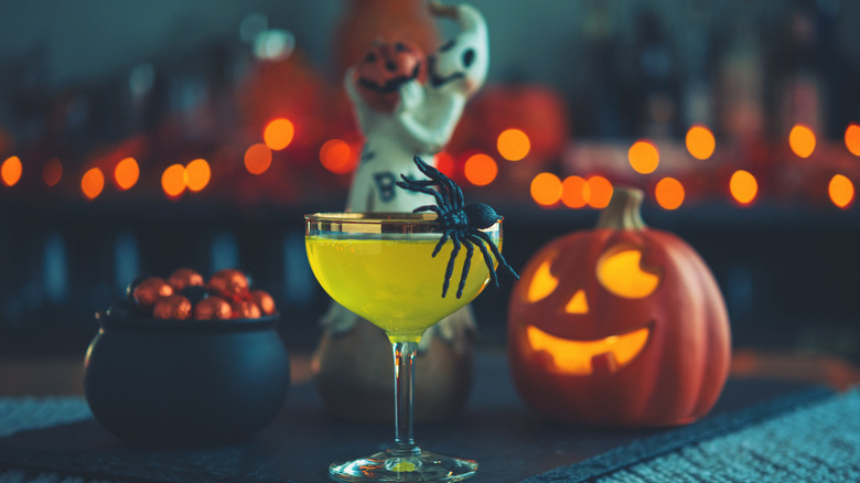 Halloween-themed drink with plastic spider garnish