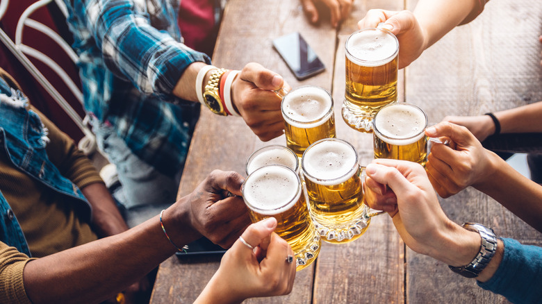 People toasting beers at beer festival 