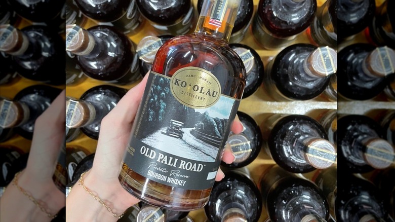 hand holding Old Pali Road bourbon