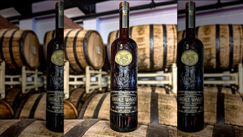 Smoke Wagon small batch bourbon in front of barrels