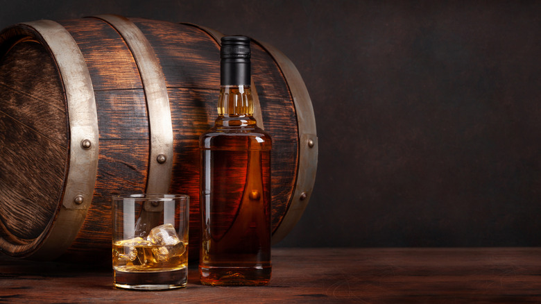 Bourbon barrel, bottle, and glass