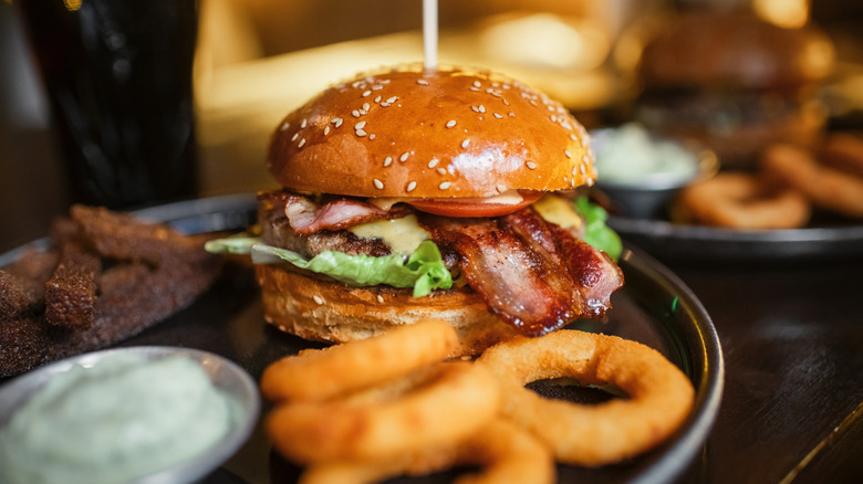 burger on a plate with onion rings