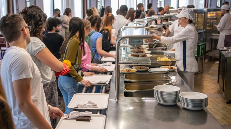 Cafeteria busy with people queuing 