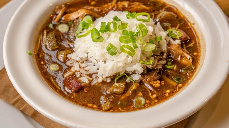 Bowl of gumbo and rice in a white bowl at Cochon restaurant in New Orleans