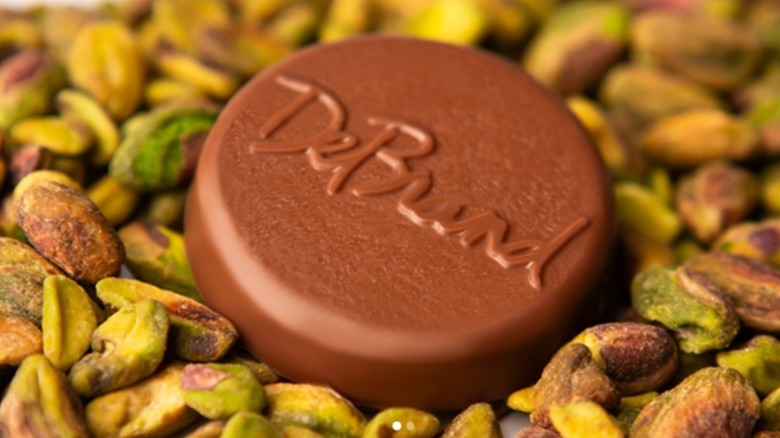 DeBrand chocolate medallion among pistachios.