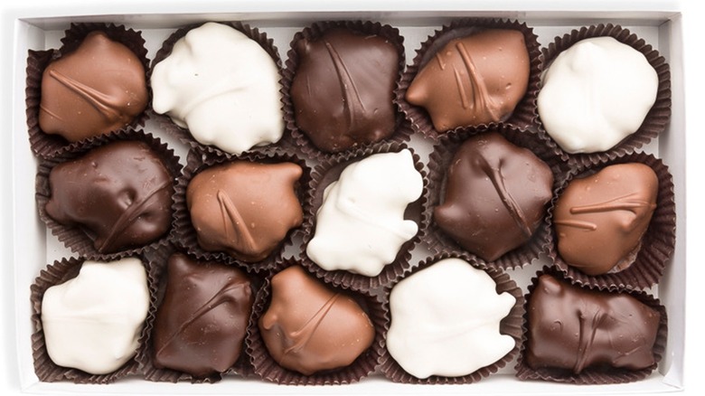 Tray of various chocolate-covered clusters.
