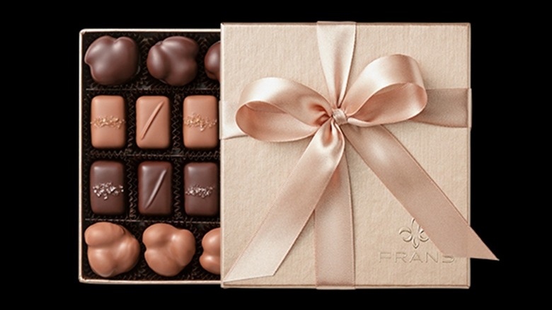 Rose gold gift box of fancy chocolates, with ribbon.