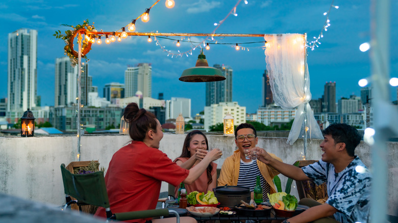 group of people toasting at outdoor dining restaurant