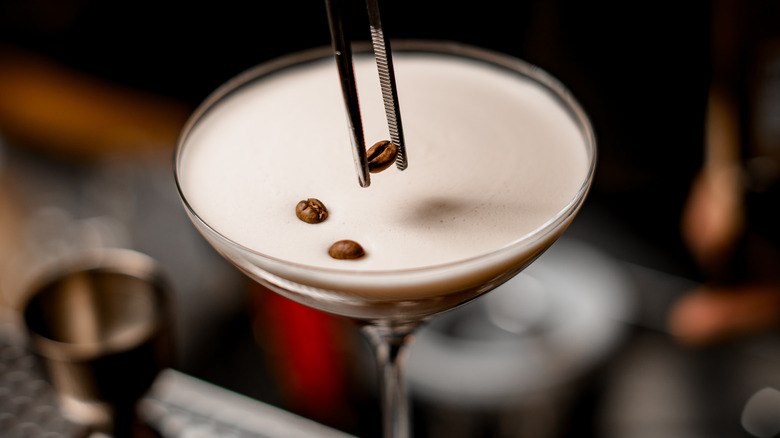 Coffee bean placed on espresso martini 