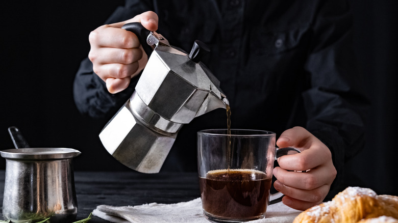 Pouring coffee from metal percolator
