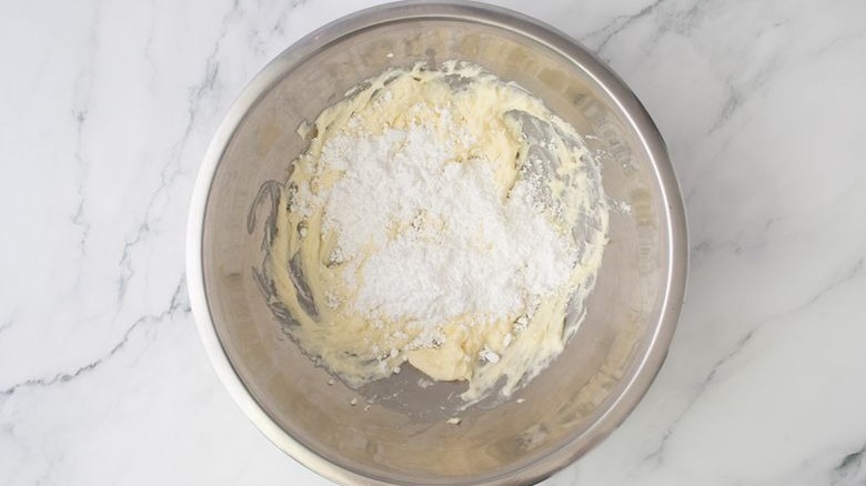 Beaten mascarpone and powdered sugar in mixing bowl