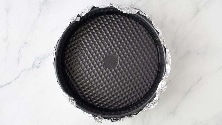 Springform pan wrapped with aluminum foil