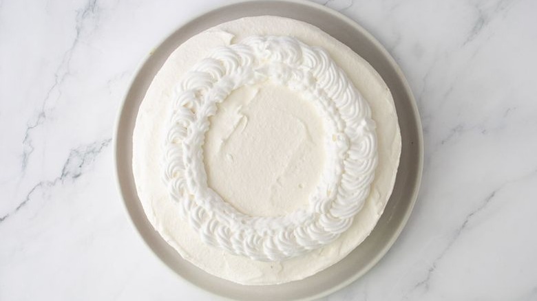 Cheesecake with decorative whipped cream piping on top