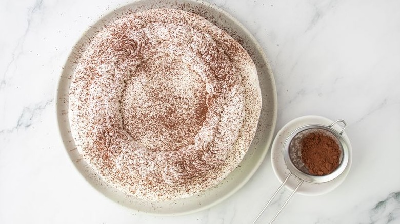Tiramisu cheesecake dusted with cocoa powder