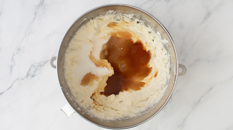 Whipped cream cheese, sugar, and espresso in mixing bowl