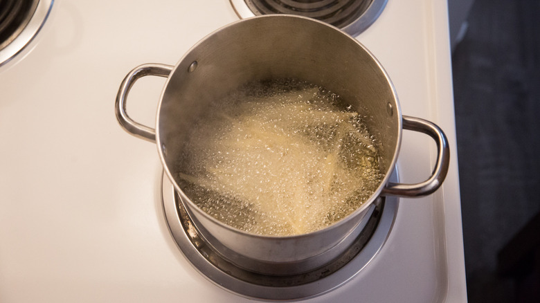 fries frying in medium pot