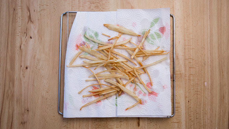 fries draining on paper towels