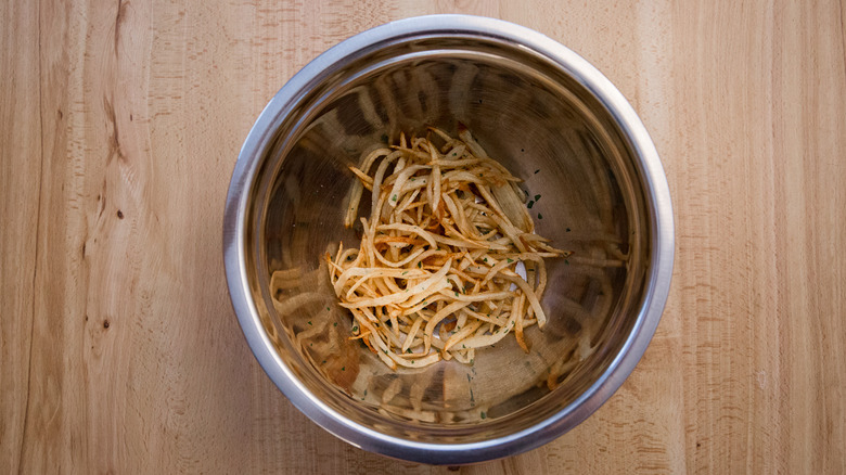 shoestring fries in mixing bowl