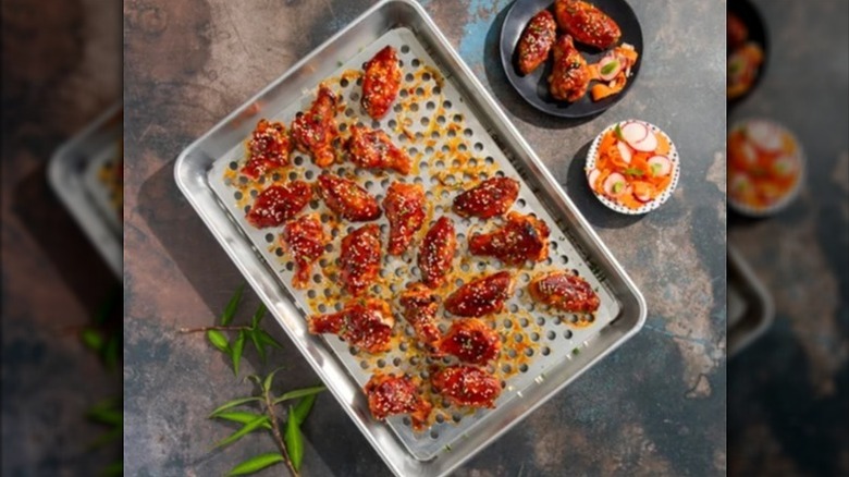 Nordic Ware metal crisping pan with many small holes in the bottom surface.