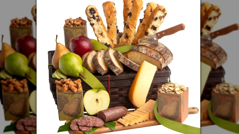 Sampler gift set with fruit, bread, meat, and cheese.