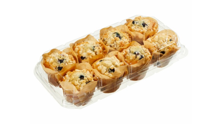 8-pack of blueberry muffins in a plastic clamshell on a white background
