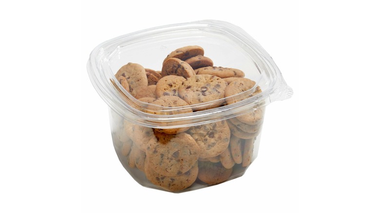 A plastic container of mini chocolate chip cookies on a white background