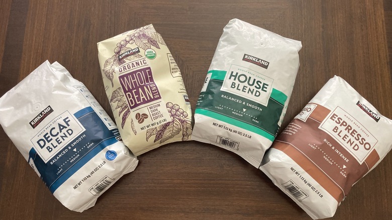 Four bags of Kirkland brand coffee spread out on table