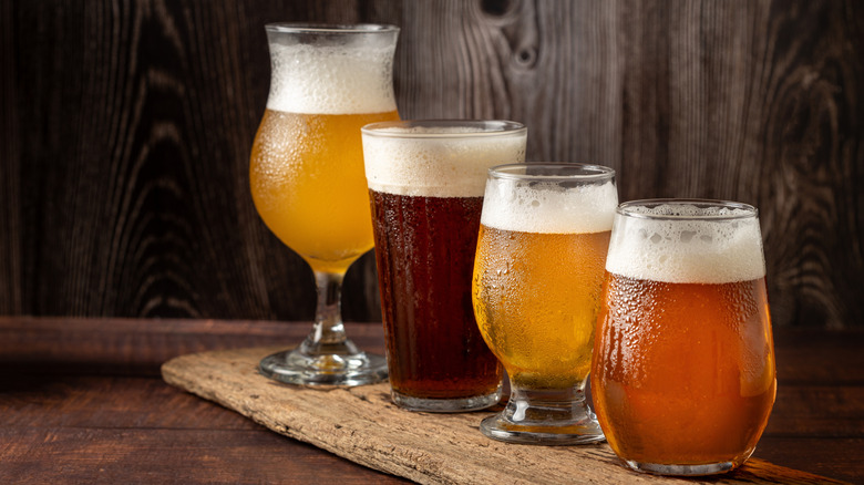Four beers in different glass styles on a wooden table