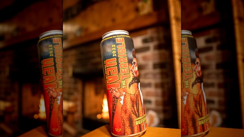 A can of Big Sky Brewing's Ivan the Terrible on a wooden ledge near a warm fireplace