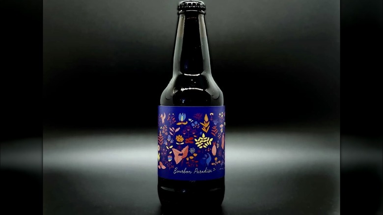 A bottle of Prairie Artisan Ales' Bourbon Paradise against a black backdrop