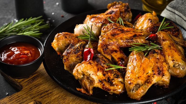 grilled chicken thighs on platter with spices 