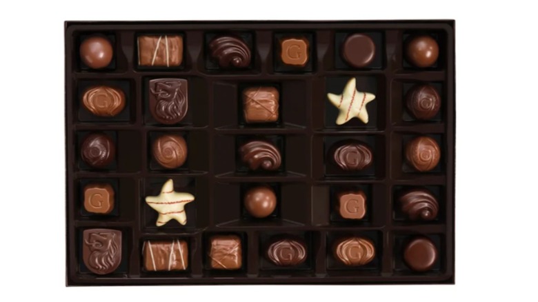 assorted pieces of godiva chocolate in open gift box