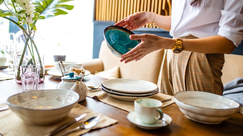 Woman looking at dinnerware