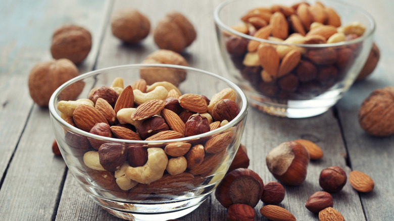 two clear bowls of mixed nuts