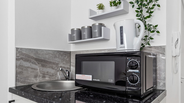 microwave and kettle on a small hotel counter