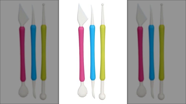 Three brightly colored cake decorating tools